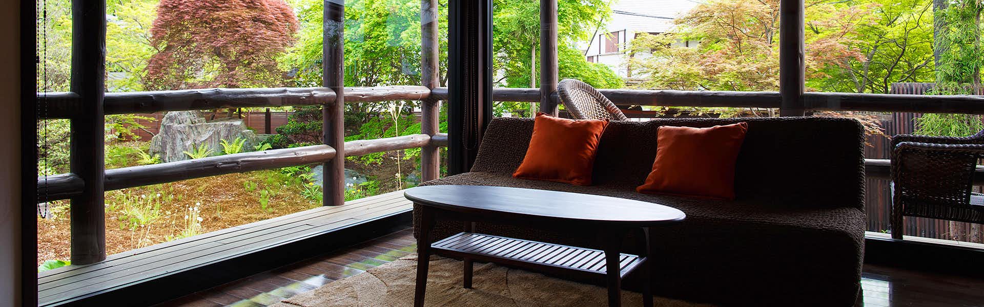Nasu no Yado Enishi with a black sofa, round table, large windows, and green garden view