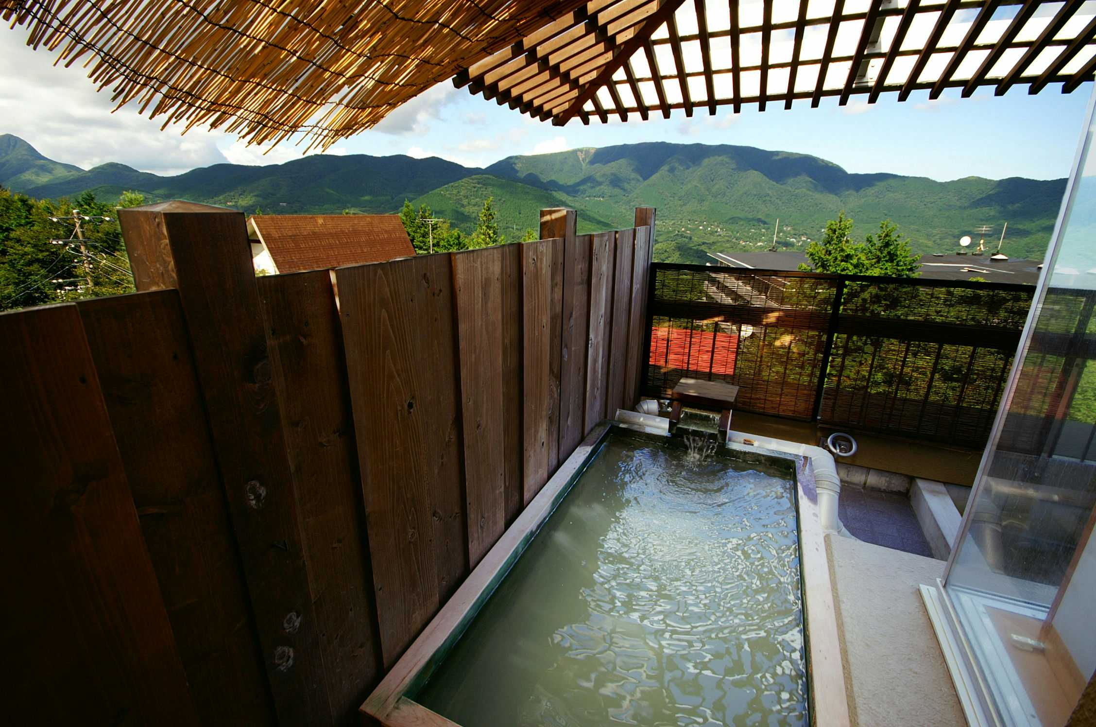 Gora Nigori no Yuyado Nounou Hakone with a private open-air bath facing green mountain peaks.