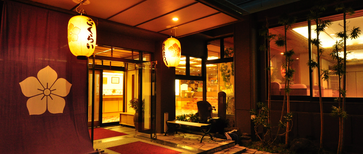 Illuminated entrance and reception facade after dark.