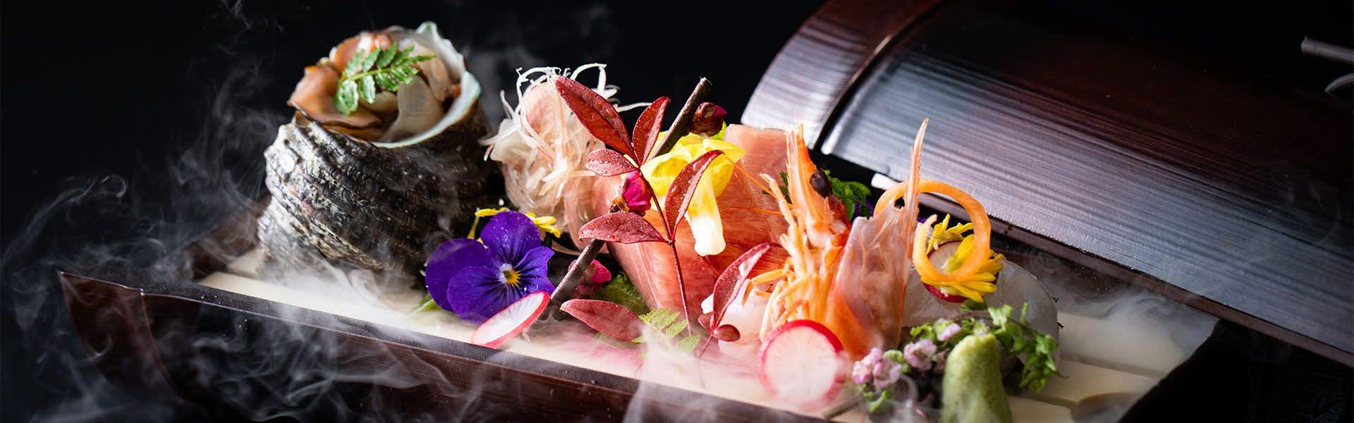 Dogo Onsen Yachiyo with colorful sashimi presented over crushed ice and flowers.