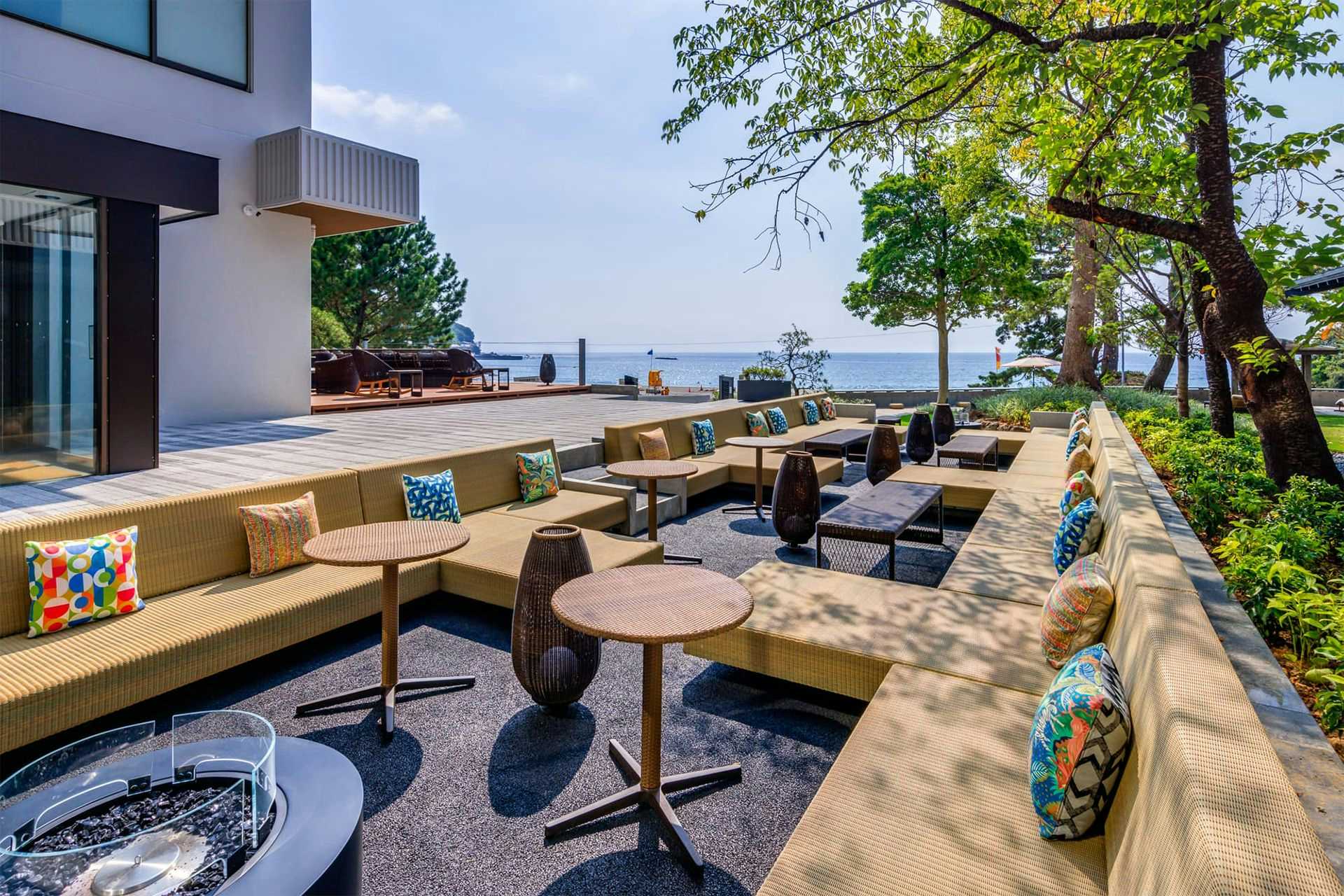 A seaside terrace with cushioned seats and ocean views.