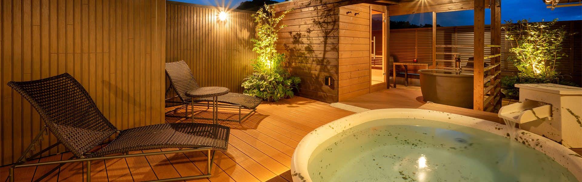 Takinoyu Hotel with a private circular bath glowing on a timber terrace.