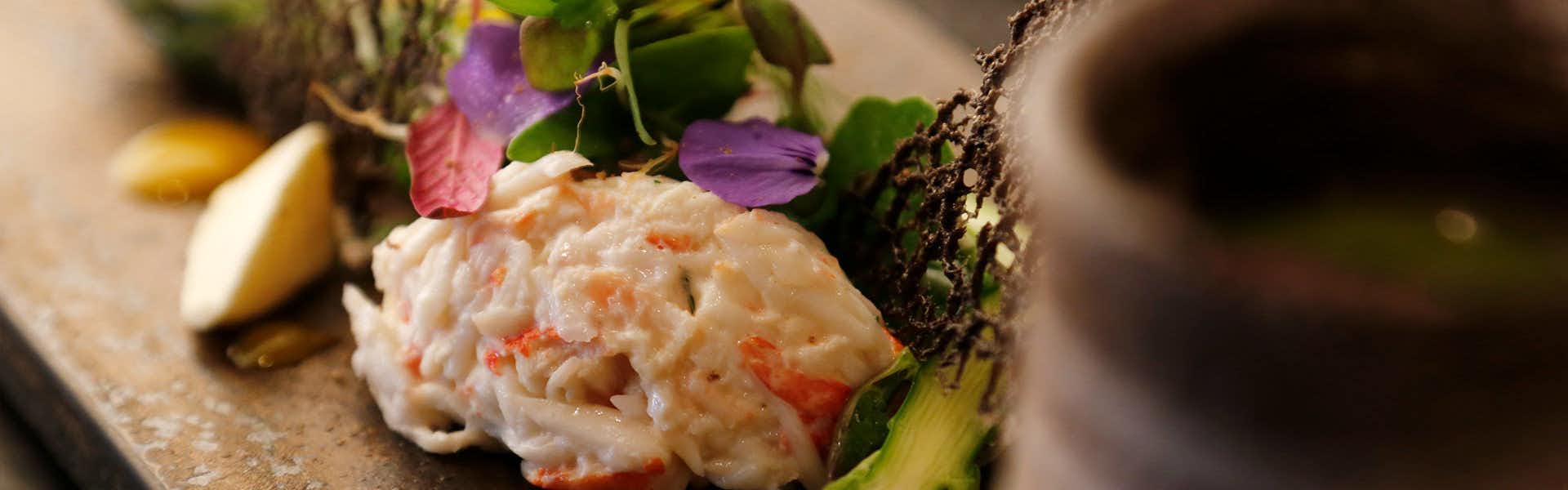 Chusui Mountain with a delicate seafood appetizer decorated with edible flowers.