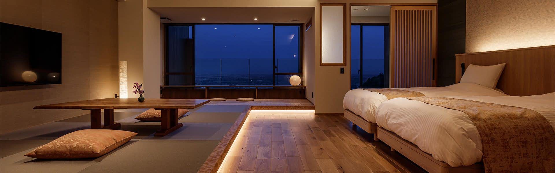 Takimotokan Yukinosato with a refined bedroom suite facing a blue-hour valley view.