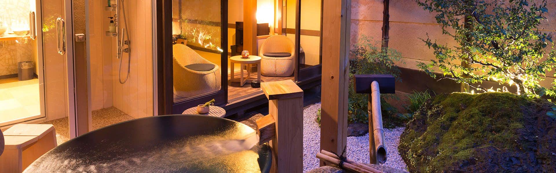 Nazuna Kyoto Nijo-jo with a private soaking bath beside a warmly lit guest room.