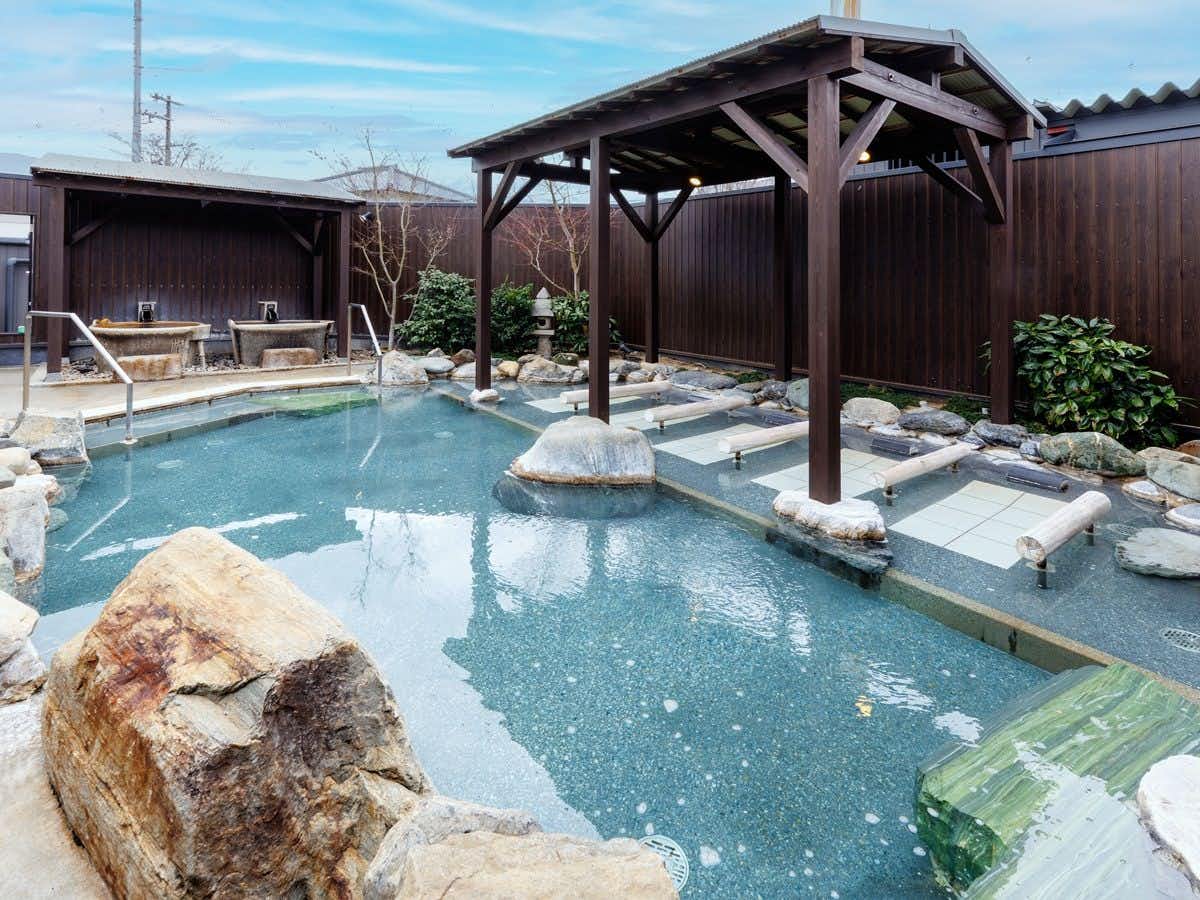 Katsuragi Onsen Happu no Yu "Yado Happu Bekkan" with an open-air stone bath surrounded by leafy garden plants.