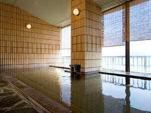 Shotenkyo with a long indoor mineral bath beside broad windows.