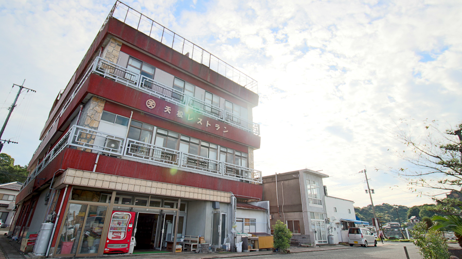 The ryokan facade beside a street.