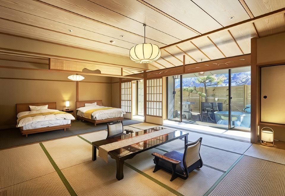 A spacious Japanese-style room with twin beds and a low table.