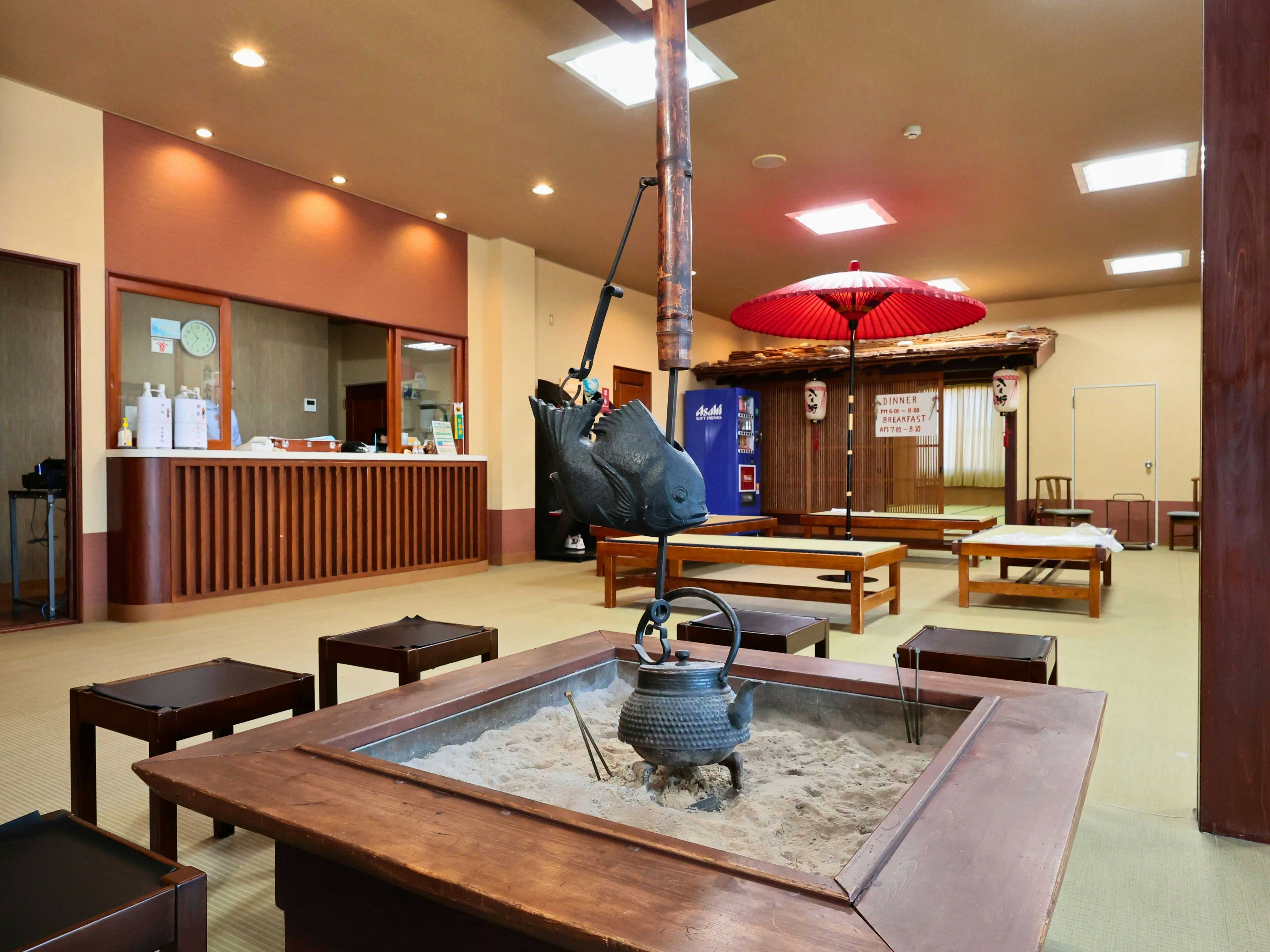 Oyado Hacihbei with a bright lobby centered on a traditional sunken hearth.