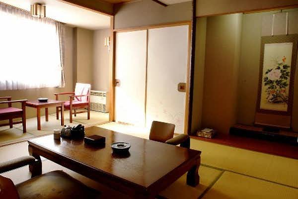 Oyado Kiyomizuya with a tatami guest room with low table and window seating.