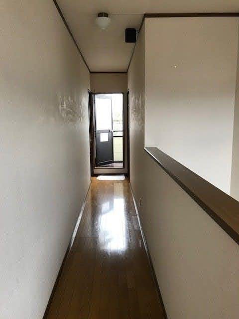 Shimanami Kaido Ryokan Fujimien with a polished hallway leading toward the guest rooms.