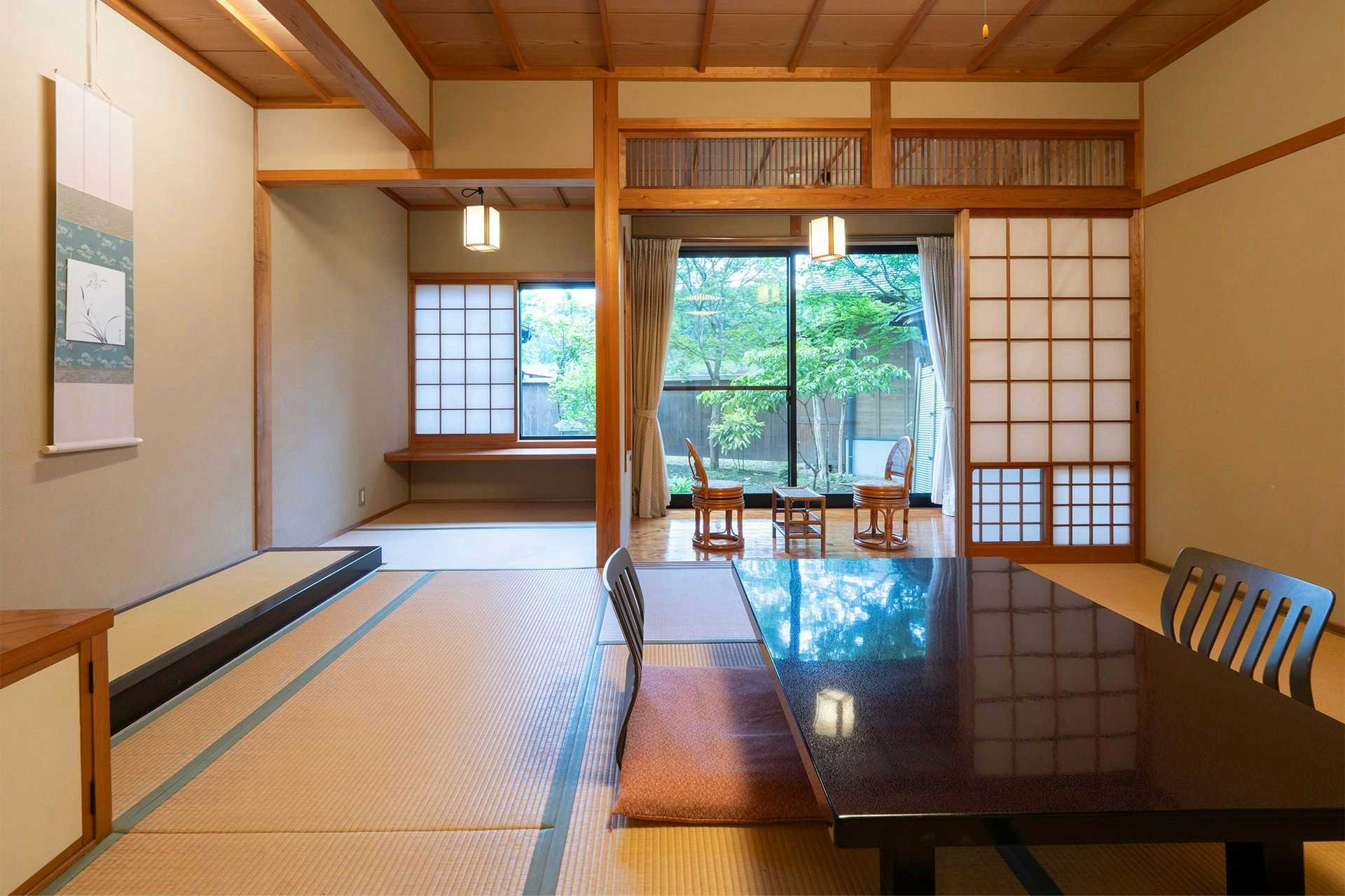 Sky Bath Mountain Lodge Hanayu with a bright tatami room with polished table and garden windows.