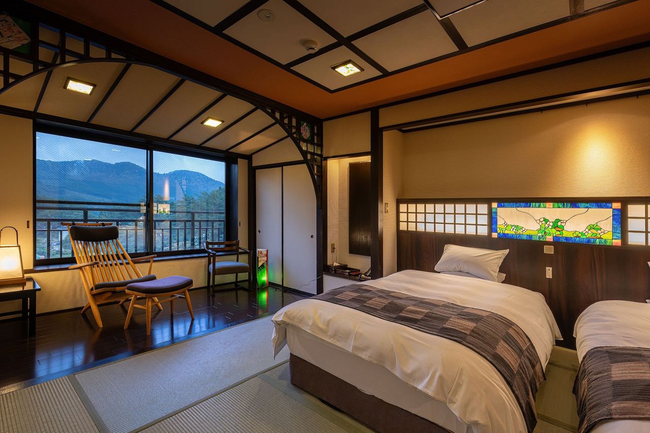 A wood-lined room opens toward a scenic landscape.